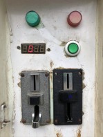 Coin slots and green button